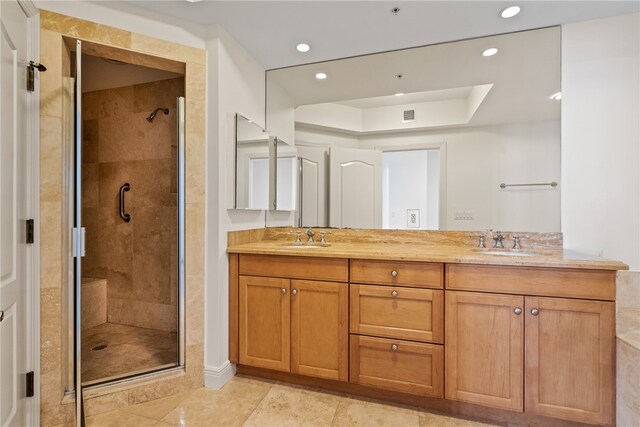 bathroom featuring tile patterned floors, vanity, and a shower with door