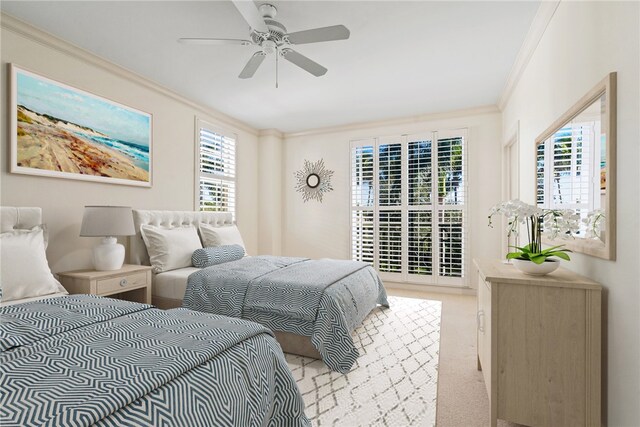 bedroom with ceiling fan, light colored carpet, multiple windows, and crown molding