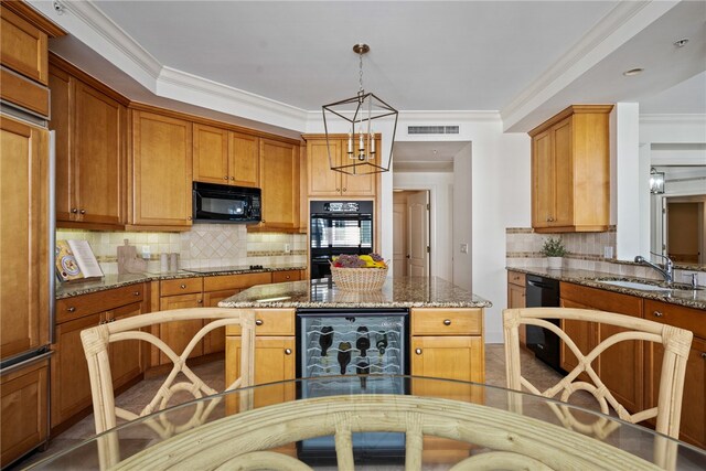 kitchen featuring black appliances, crown molding, and stone countertops