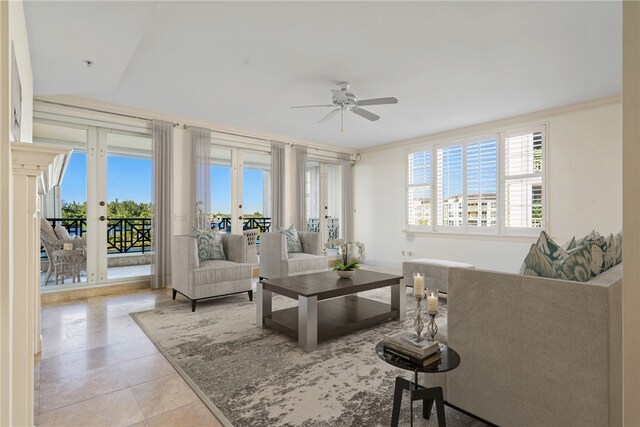 living room featuring ornamental molding, light tile patterned flooring, ceiling fan, and a healthy amount of sunlight