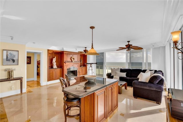 living room with a water view and ceiling fan