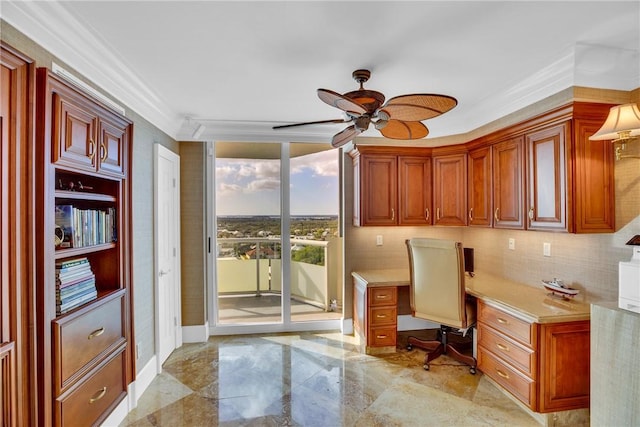 home office with crown molding, ceiling fan, built in desk, and a wall of windows