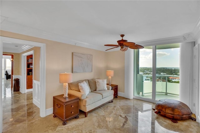 living room featuring ceiling fan and floor to ceiling windows