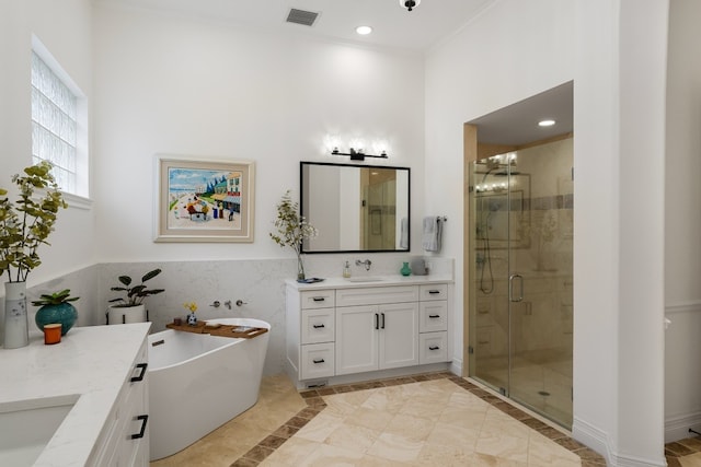 bathroom featuring tile patterned floors, shower with separate bathtub, vanity, tile walls, and ornamental molding