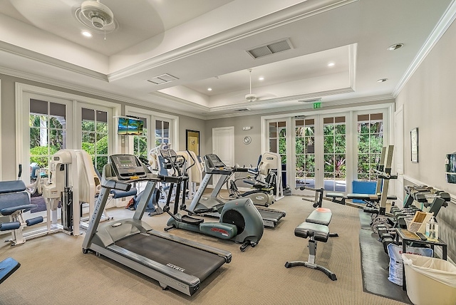 gym featuring carpet floors, ceiling fan, a raised ceiling, crown molding, and french doors