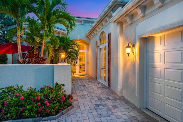 exterior space featuring french doors and a garage