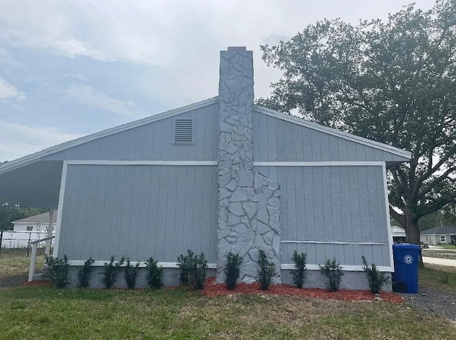 view of side of home featuring a yard