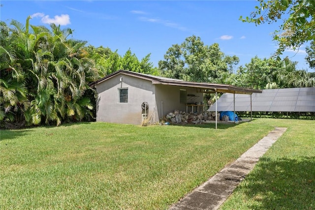 5541 Teal Ter, Fort Pierce, FL 34982 - rear view of property with stucco siding and a lawn