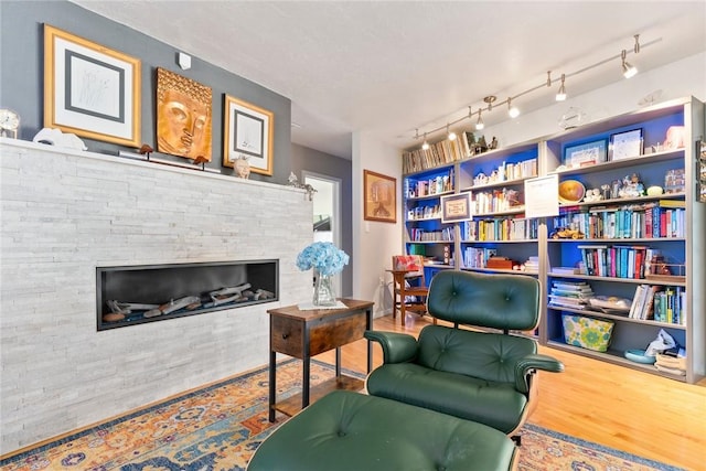 5541 Teal Ter, Fort Pierce, FL 34982 - sitting room featuring wood finished floors, a fireplace, and built in shelves