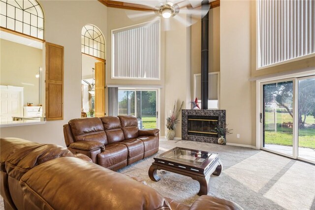 420 Sopwith Dr, Vero Beach, FL 32968 - living area with a high ceiling, carpet flooring, ceiling fan, baseboards, and a high end fireplace