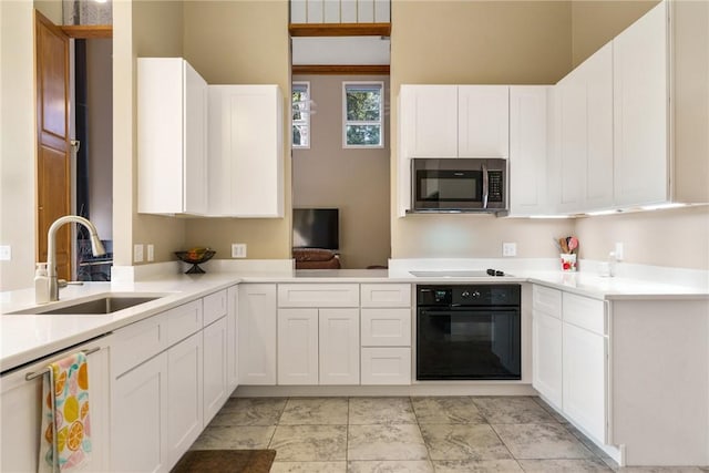 420 Sopwith Dr, Vero Beach, FL 32968 - kitchen with oven, stainless steel microwave, a sink, electric stovetop, and light countertops