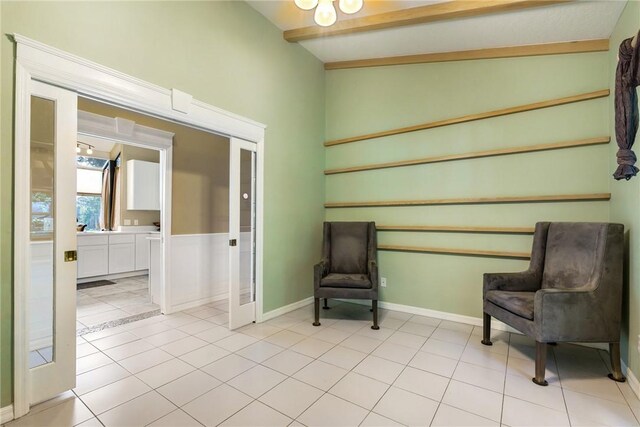 420 Sopwith Dr, Vero Beach, FL 32968 - sitting room with light tile patterned floors, baseboards, and french doors