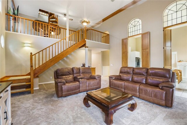 420 Sopwith Dr, Vero Beach, FL 32968 - carpeted living room with a towering ceiling, stairs, ceiling fan, and crown molding