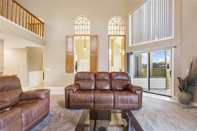420 Sopwith Dr, Vero Beach, FL 32968 - tiled living room featuring a towering ceiling and baseboards