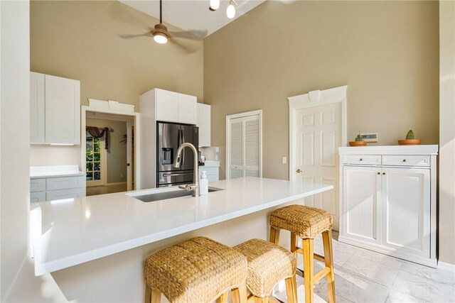 420 Sopwith Dr, Vero Beach, FL 32968 - kitchen featuring high vaulted ceiling, stainless steel fridge with ice dispenser, a ceiling fan, white cabinetry, and a sink