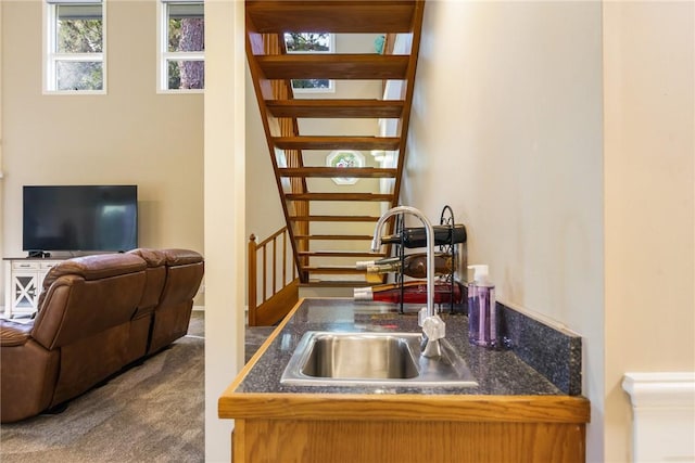 420 Sopwith Dr, Vero Beach, FL 32968 - kitchen with a sink, dark countertops, open floor plan, and carpet flooring