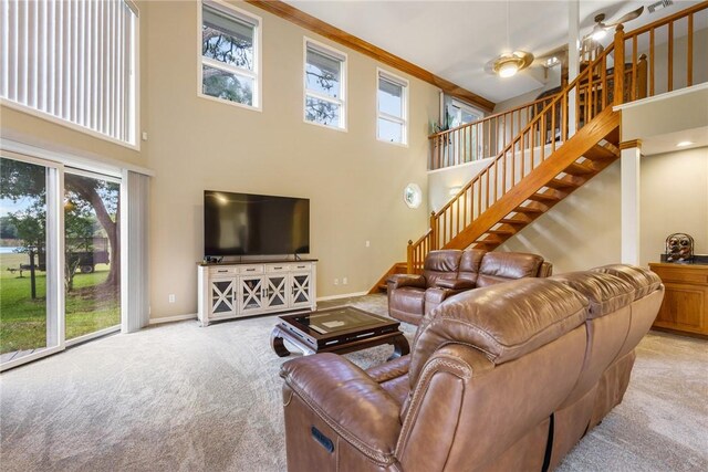 420 Sopwith Dr, Vero Beach, FL 32968 - carpeted living area featuring a high ceiling, stairway, baseboards, and ornamental molding