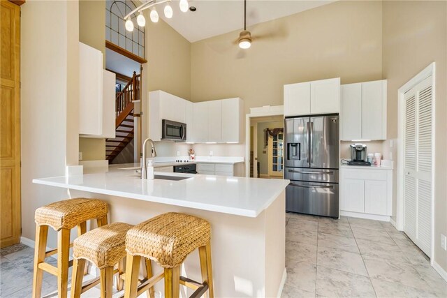 420 Sopwith Dr, Vero Beach, FL 32968 - kitchen featuring stainless steel refrigerator with ice dispenser, a high ceiling, a sink, baseboards, and light countertops