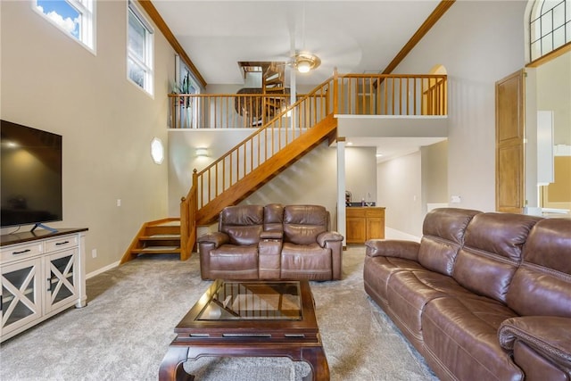 420 Sopwith Dr, Vero Beach, FL 32968 - carpeted living room featuring a high ceiling, ceiling fan, stairway, and baseboards
