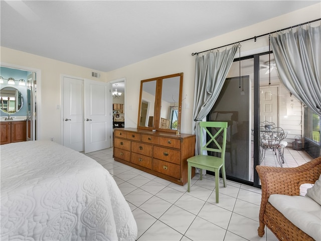 bedroom featuring light tile patterned floors, sink, and connected bathroom