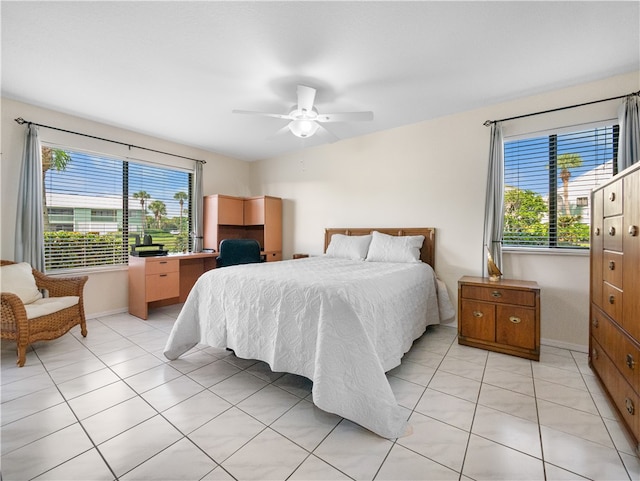 tiled bedroom featuring ceiling fan