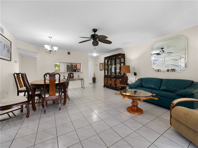 living room with ceiling fan with notable chandelier and light tile patterned floors