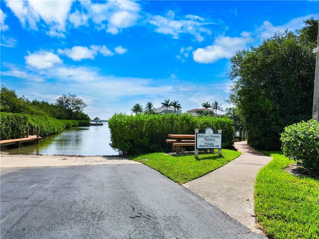 view of property's community featuring a water view and a yard