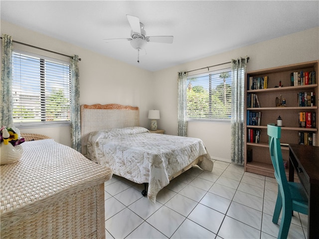 tiled bedroom featuring multiple windows and ceiling fan