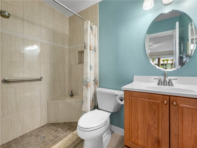 bathroom with curtained shower, vanity, tile patterned floors, and toilet