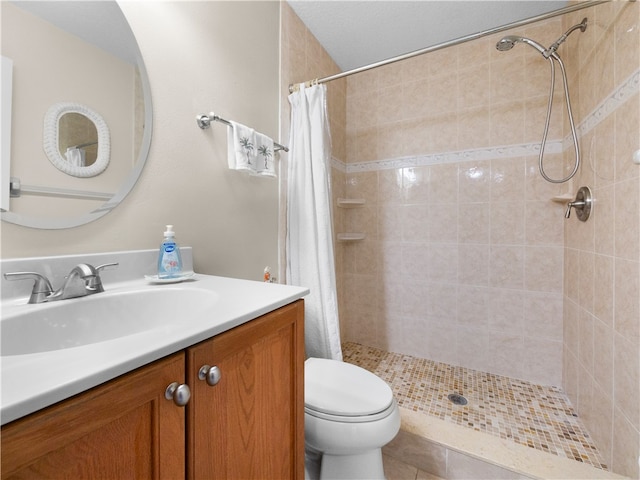 bathroom with toilet, vanity, tile patterned flooring, and curtained shower