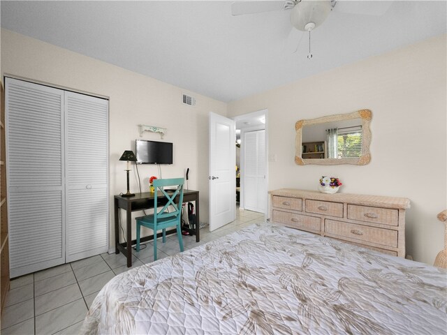 tiled bedroom featuring ceiling fan and a closet