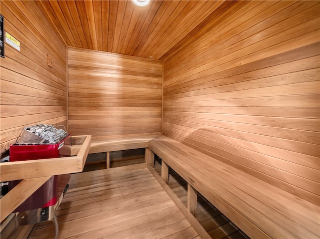 view of sauna / steam room featuring wood walls, wood-type flooring, and wood ceiling