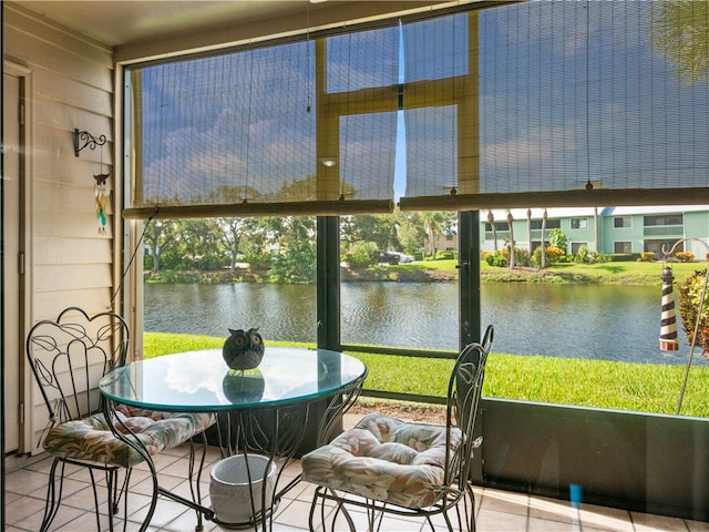 sunroom / solarium with a water view