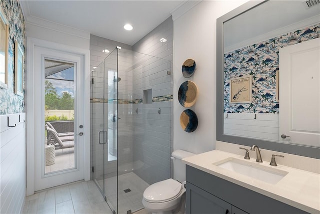 bathroom with toilet, crown molding, a shower with shower door, and vanity