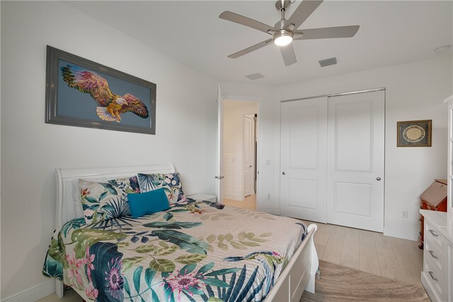 bedroom with ceiling fan, a closet, and light wood-type flooring