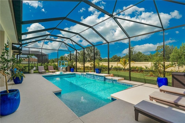 view of pool featuring a lanai, pool water feature, and a patio