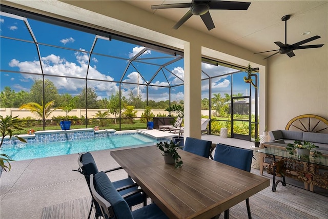 view of pool with glass enclosure, outdoor lounge area, pool water feature, and a patio