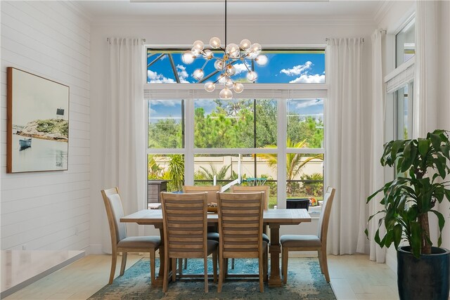 dining area featuring crown molding and a chandelier