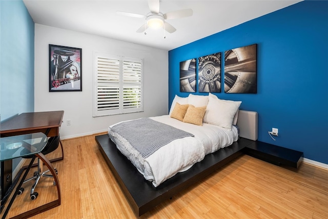 bedroom featuring ceiling fan and hardwood / wood-style flooring