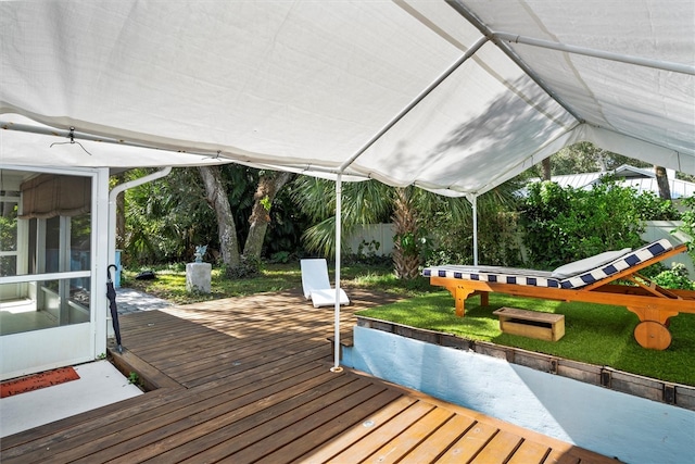 deck featuring a lawn and a sunroom