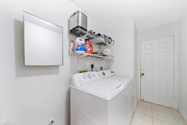 laundry area featuring light tile patterned flooring and independent washer and dryer