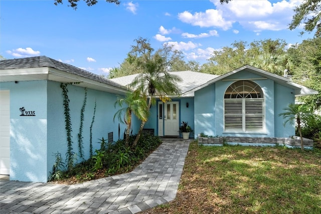 view of front of house with a front yard and a garage