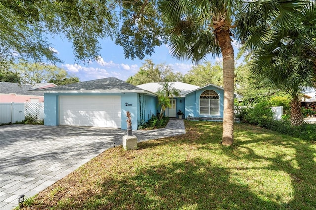 ranch-style home with a garage and a front yard