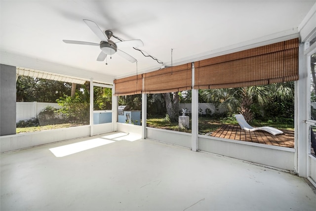 unfurnished sunroom featuring ceiling fan