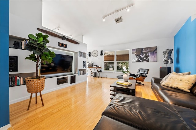 living room featuring hardwood / wood-style floors and track lighting