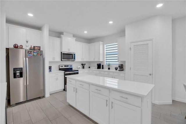 102 52nd Sq, Vero Beach, FL 32967 - kitchen with light countertops, white cabinets, recessed lighting, and stainless steel appliances