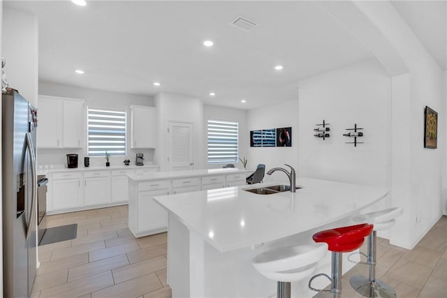 102 52nd Sq, Vero Beach, FL 32967 - kitchen with plenty of natural light, stainless steel refrigerator with ice dispenser, a center island with sink, and a sink