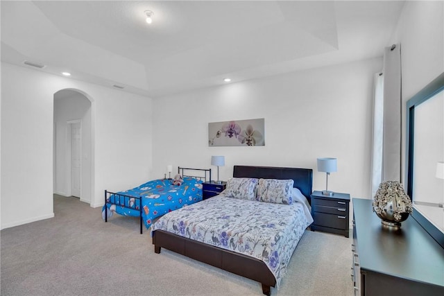102 52nd Sq, Vero Beach, FL 32967 - carpeted bedroom with baseboards, recessed lighting, visible vents, a raised ceiling, and arched walkways
