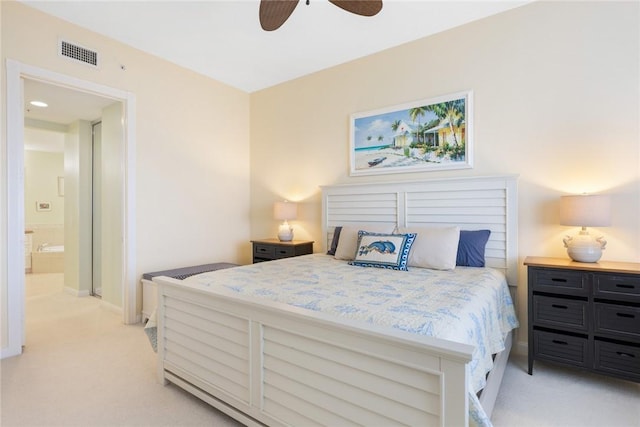 bedroom with ensuite bath, ceiling fan, and light colored carpet