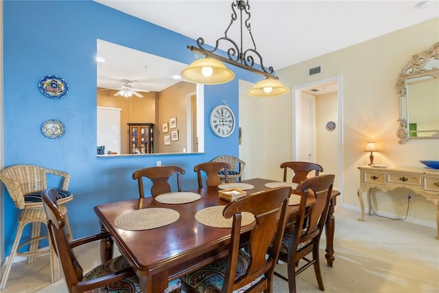 dining room featuring light carpet and ceiling fan